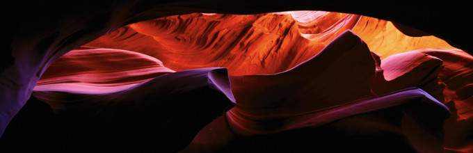 Slot Canyon, ARIZONA. Sculpted by water and wind, the slot canyons in northwestern Arizona have become one of the prime destinations for photographers throughout the world. When the sun is highest in the sky, reflected rays reach into the subterranean.