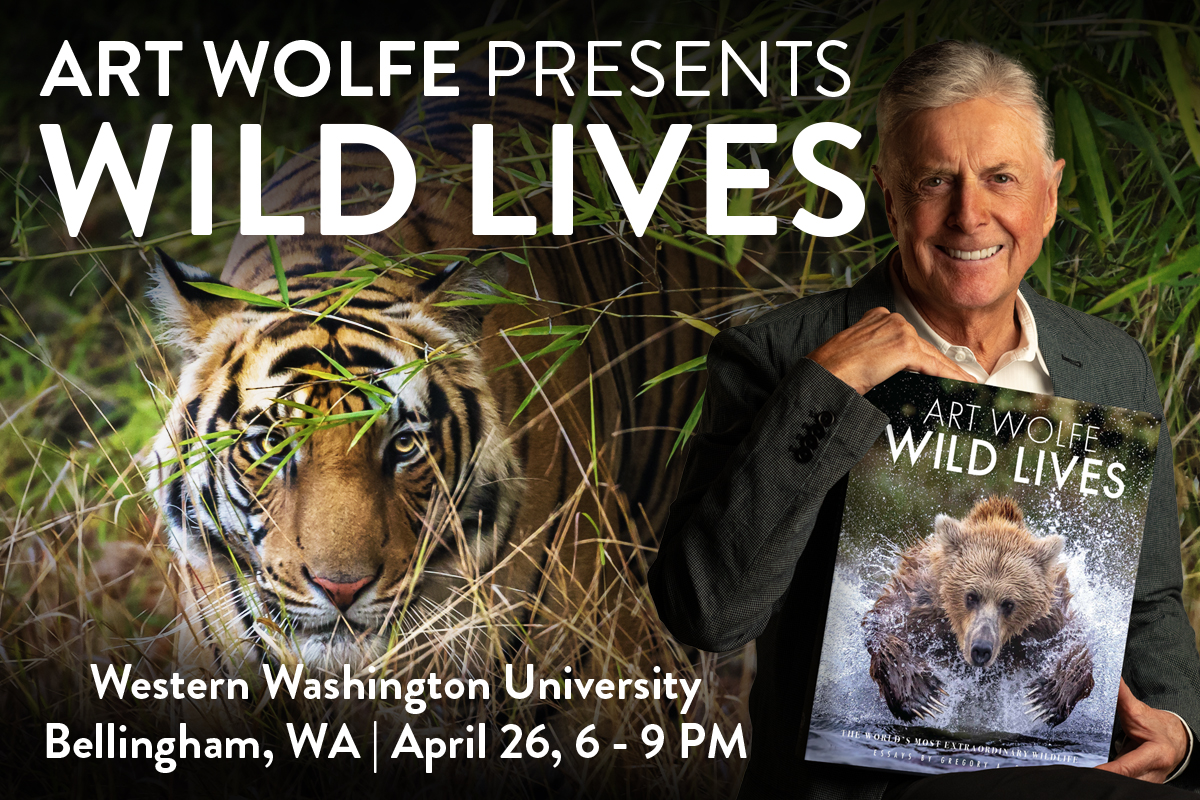 Photographer Art Wolfe holding a copy of his latest book, WILD LIVES.