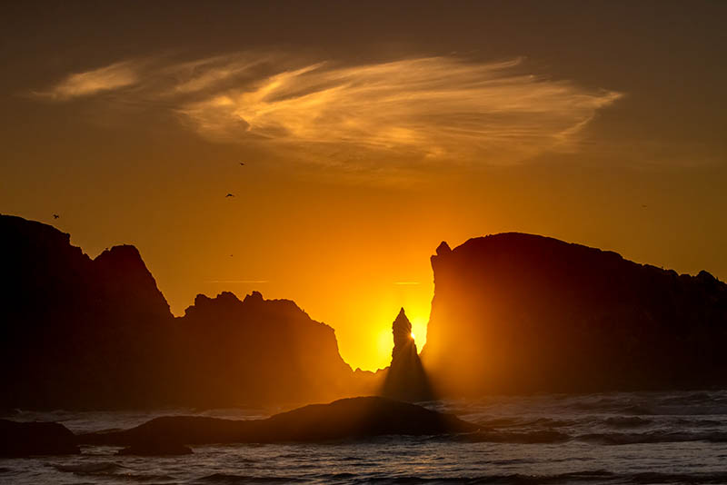 Sunset silhouettes sea stacks on the coast of Bandon, Oregon